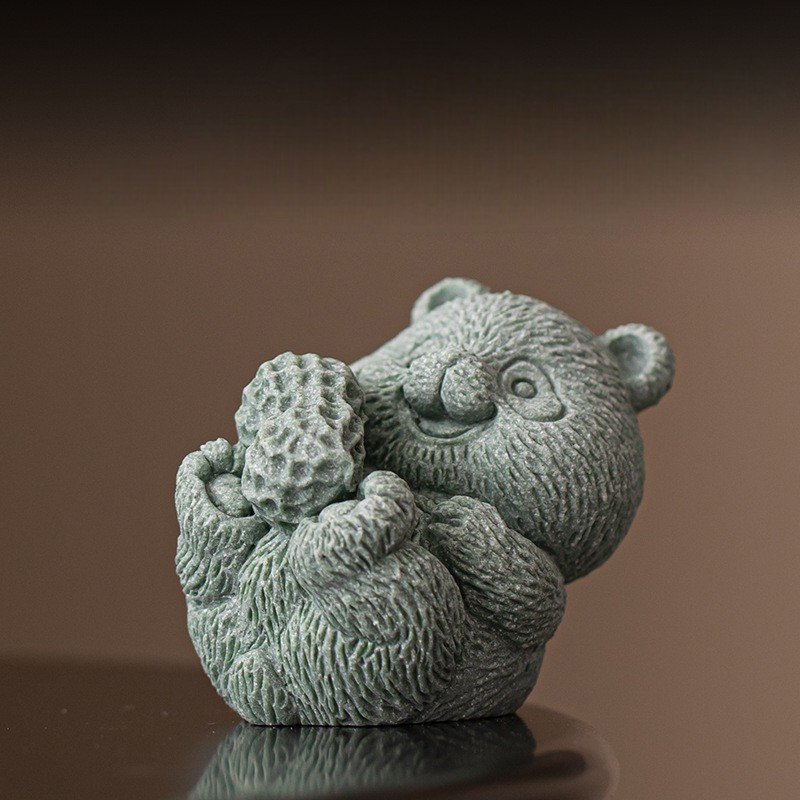 Abundance" panda statue holding a peanut