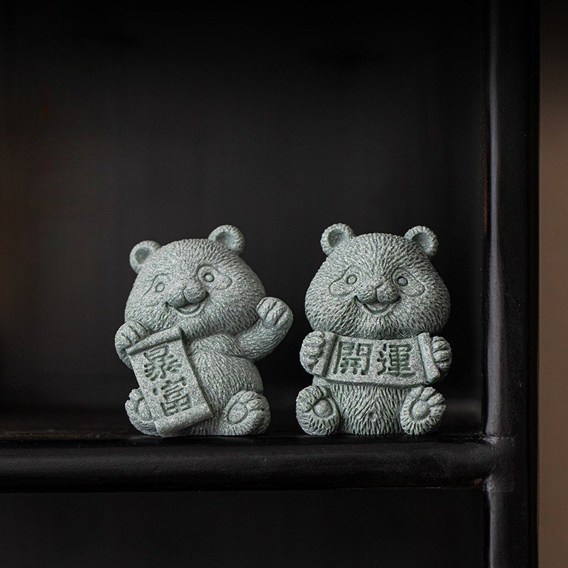 A collection of cute panda tea pets in green sandstone